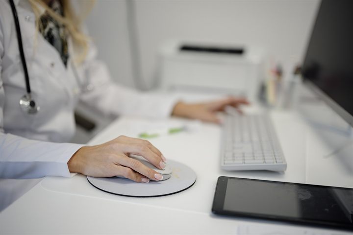 Clinician working at a computer in a medical office